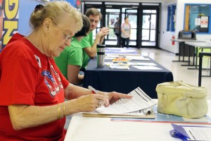 Sandra Heatherley fills out forms at the voting registration table inside the Harvin Center on East Campus Sept. 27.