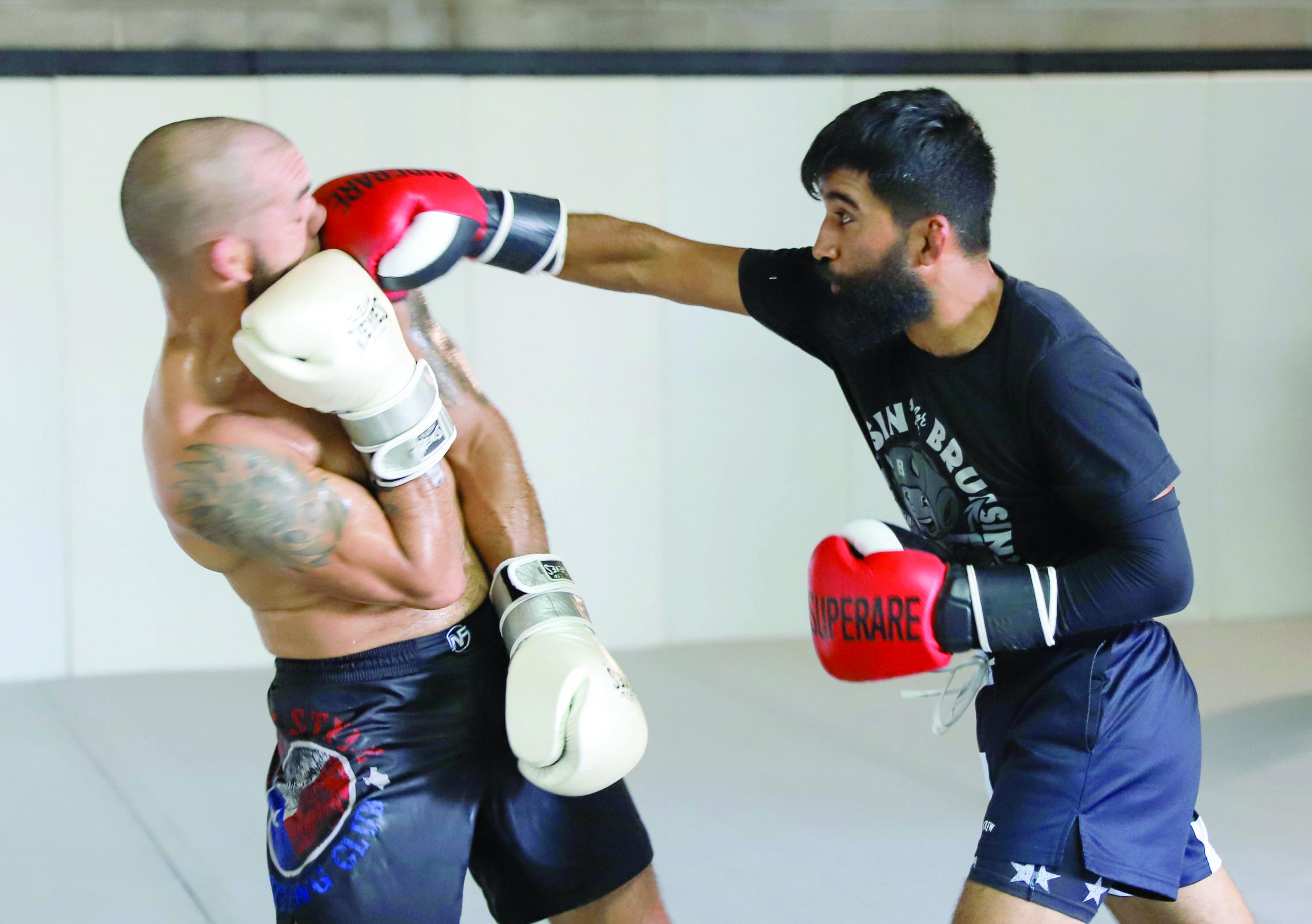 Green Lands A Solid Punch During Sparring Session With David De Los Santon, Owner And Head Coach Of Kaizen Kombat Academy.
