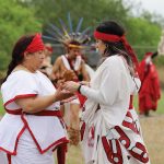 Between each danza, members perform the Nahui olli movement, representing the cyclical movement of nature with respect to the four directions, to pass items from drum sticks to their flags.