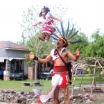 Daniel Malinalteotl Cruz tosses his daughter in the air during the danza.