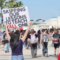 Miller and Ray high school students hold protest signs as they march down Shoreline Boulevard heading to Corpus Christi City Hall on Feb. 12.