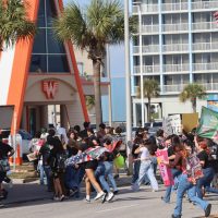 Students from Miller and Ray high schools cross Shoreline Boulevard as they walk from Water's Edge Park to City Hall on Feb. 12. Student participated in a walkout to protest ICE prescence in their community.