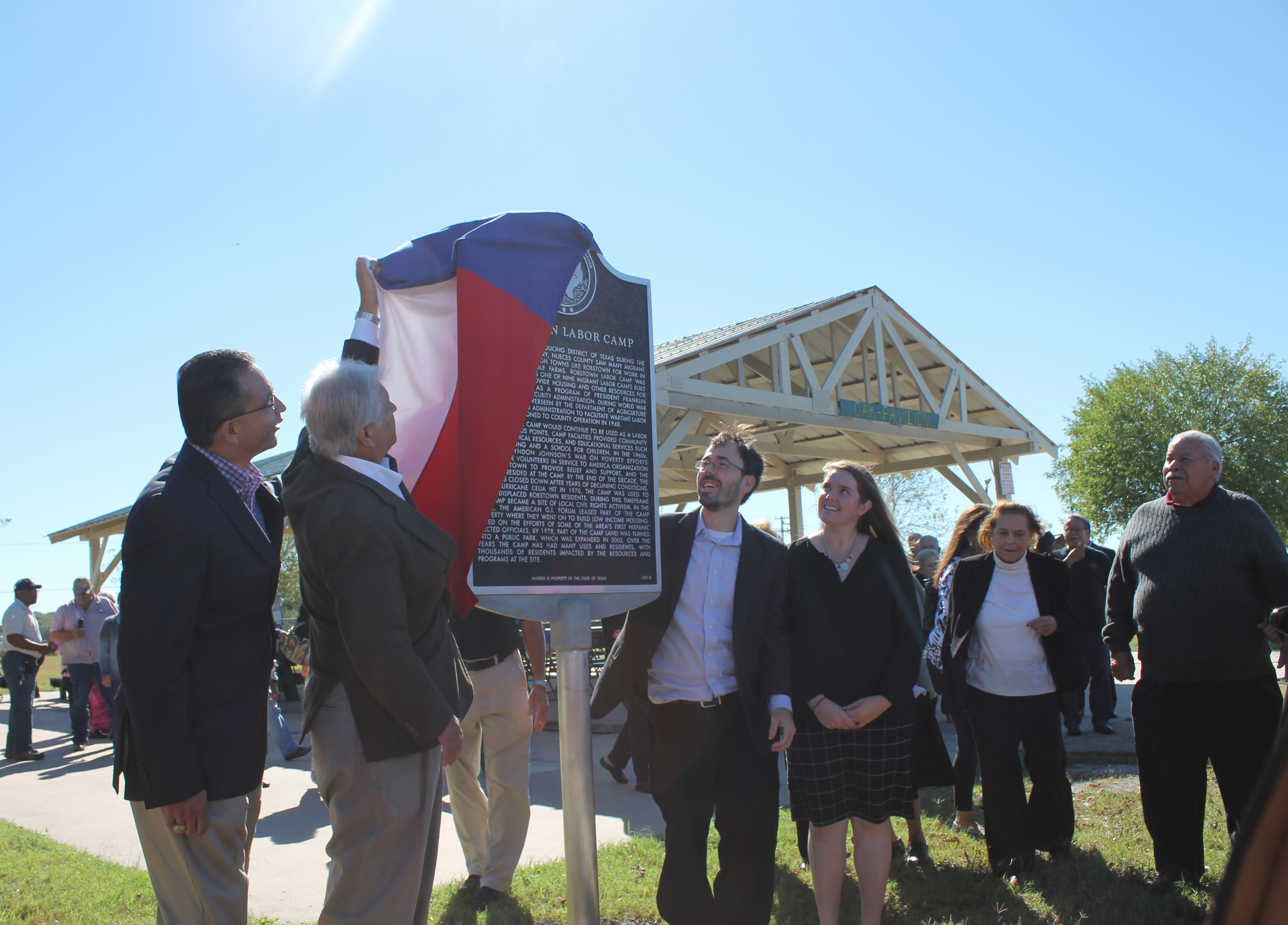Left to right: State Representative Abel Herrero, Commissioner Oscar Ortiz, Mark Robbins and Christine Robbins unveiling the historical landmark.