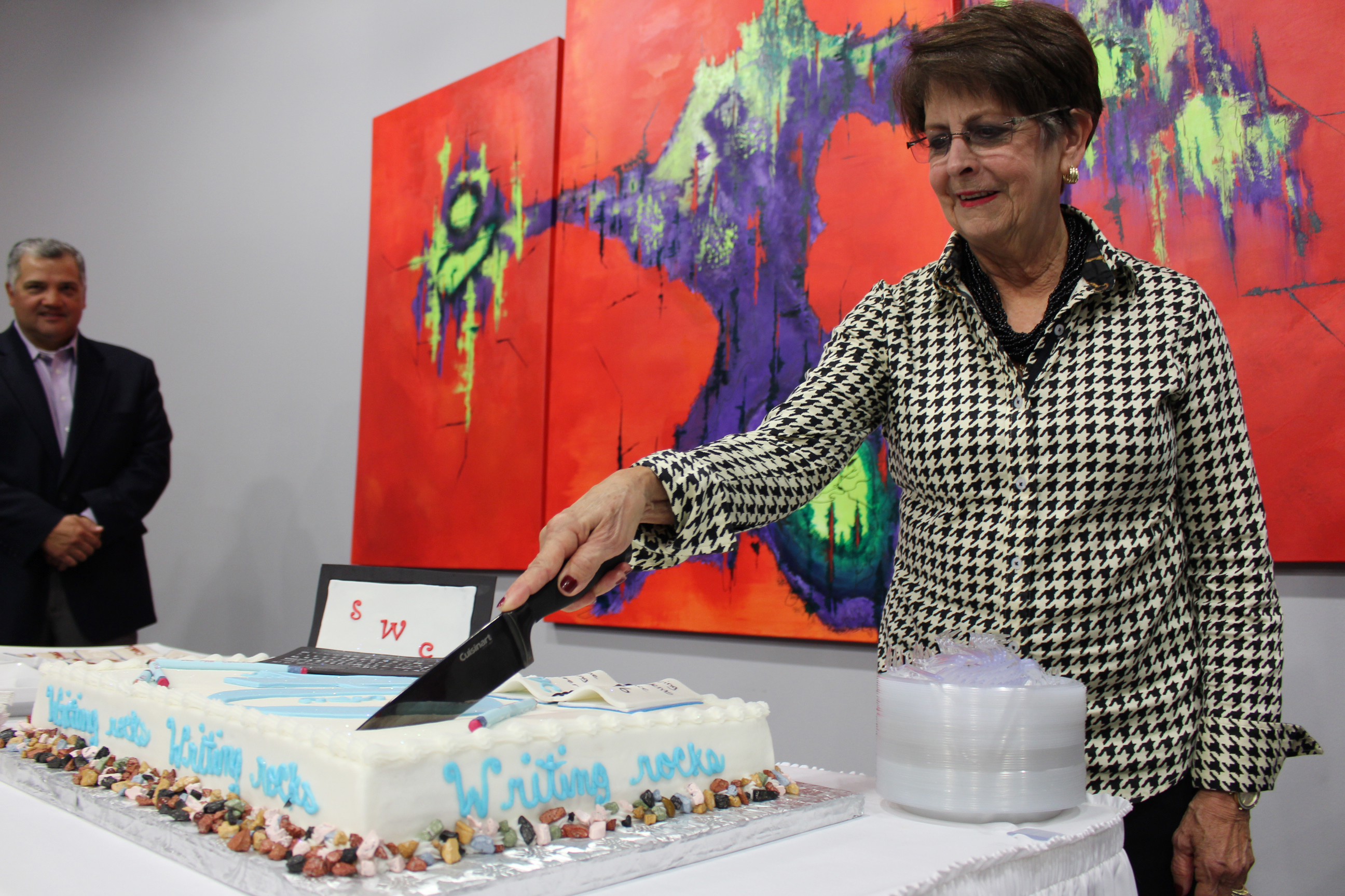 Kay Stone Land as a honored guest cuts the cake at Stone Writing Center's "40" Celebration.