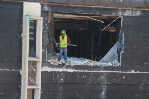 A worker continues to gut the second floor of the English Building on Monday.