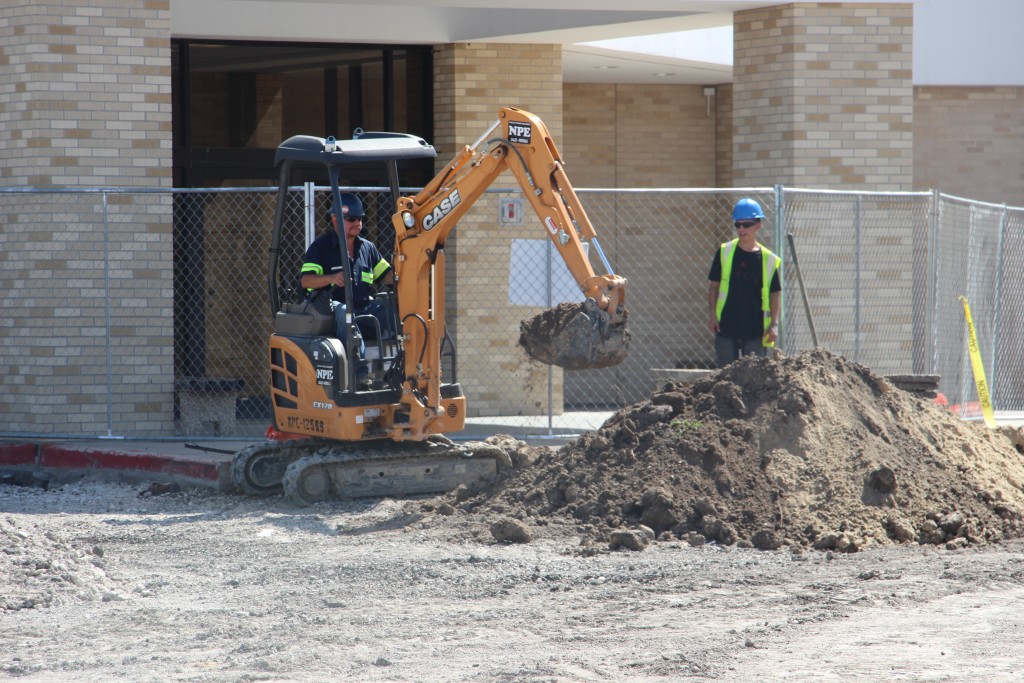 Crews remove the last of the Harvin Center parking lot on Monday.