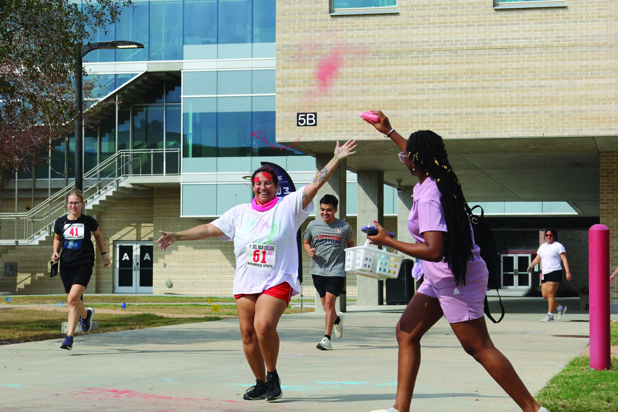 Volunteer Precious Haddison Blasts Dye Onto Merced Aceves As She Crosses The First Color Station During The Intramural Sports Color Run On Wednesday Nov. 19 At The Heritage Campus.