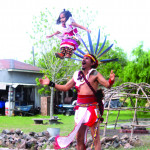 Daniel Malinalteotl Cruz tosses his daughter in the air during the danza.