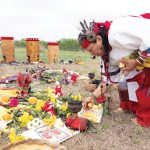 Delia Tufino, sanadora or female healer, arranges fruit, flowers, elements, and blessings before the beginning of the ceremony.