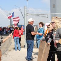 Attendees of Trump event (Left) Deanna Olesinky interacting with protesters (from left to right) Amanda (no last name given) and Lily Riggs.