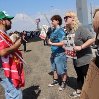 Ray Reys, a Trump Supporter speaking with protesters (from left to right) Heidi Riggs, Lily Riggs, and Amanda (no last name given).