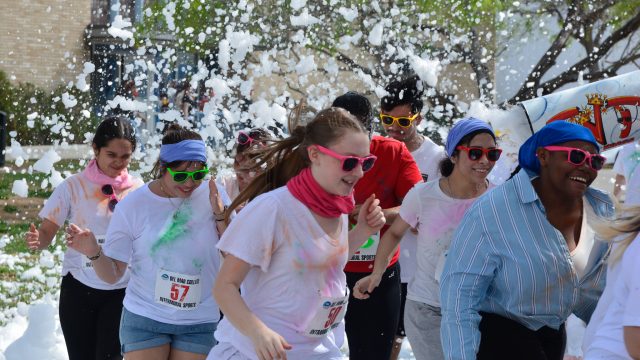 Runners blast through the foam at the DMC Color Run on March 4. Photo by Rogelio Garcia
