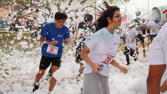Runners go through the foam at the March 4 Color Run on Del Mar's Heritage Campus. Photo by Victor Herrera.