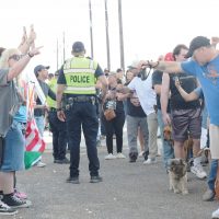 Police standing to keep the peace between protesters and event attendees in line during President Trump's visit to the Port of Corpus Christi on Feb. 27.