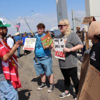Ray Reys, a Trump supporter speaking with protesters (from left to right) Heidi Riggs, Lily Riggs, and Amanda (no last name given).